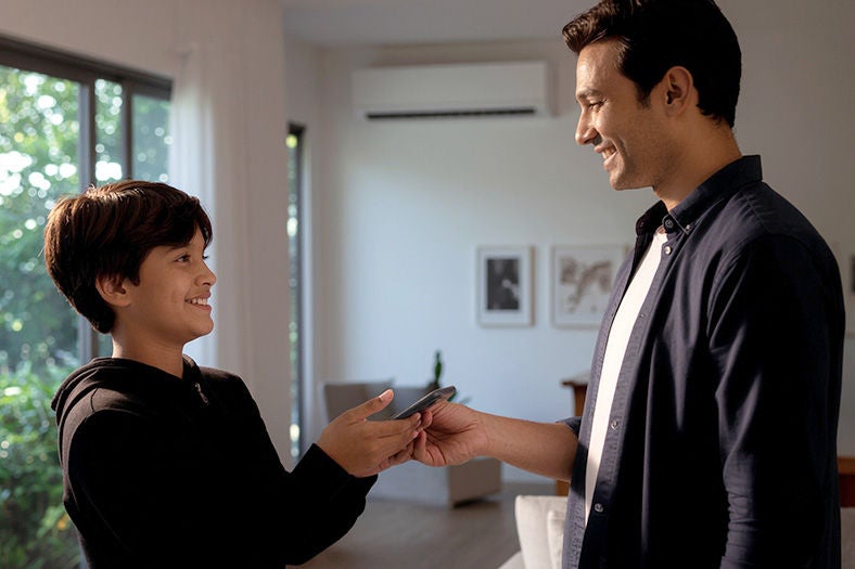 Father giving his child their 1st smartphone running on Optimum Mobile