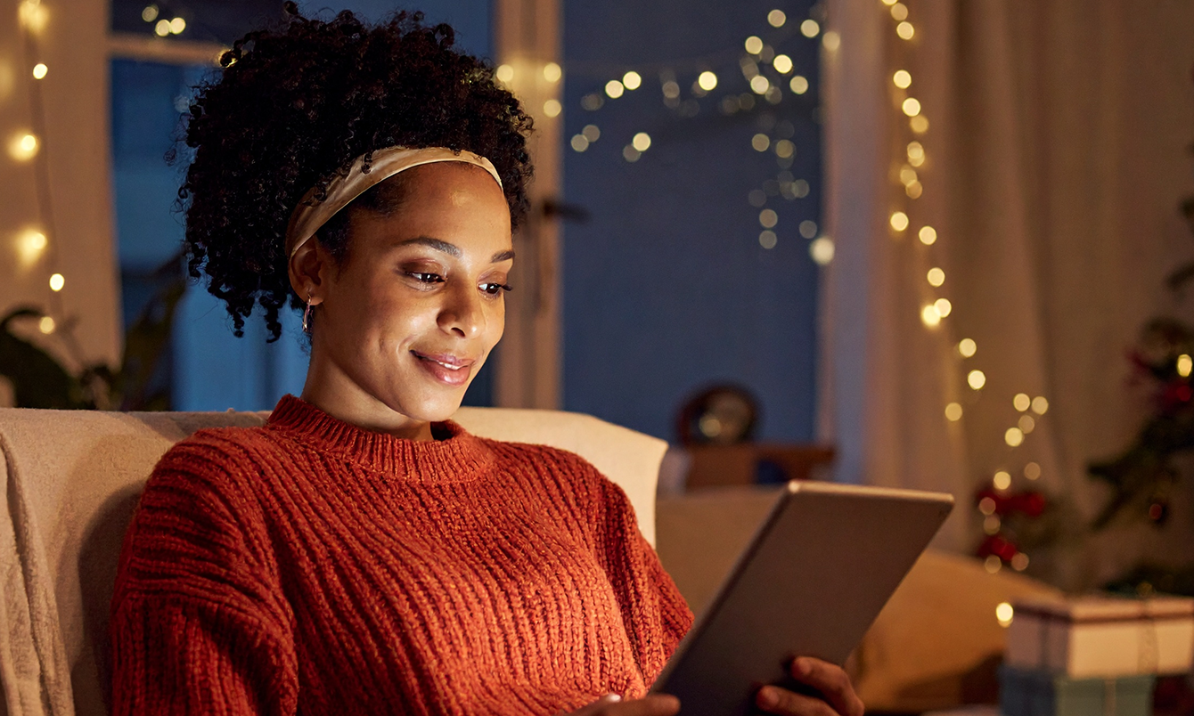 Woman using her tablet to search the Internet with Optimum Fiber