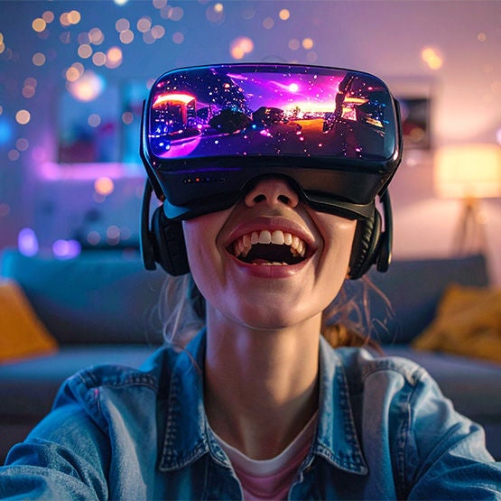 Person wearing VR headset smiling — gaming with ultra-fast Optimum Fiber Internet